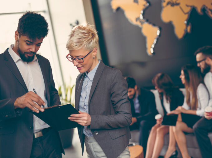 Business people working together in front of a world map