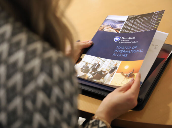 Student looking at graduate program booklet