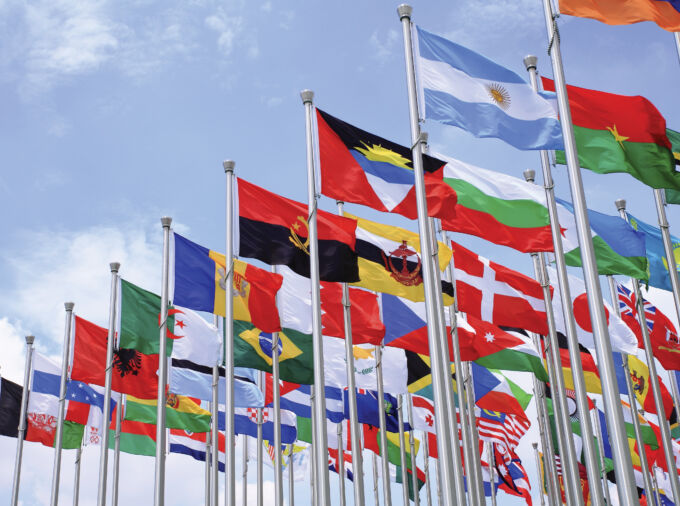 Group of international flags on a blue sky background