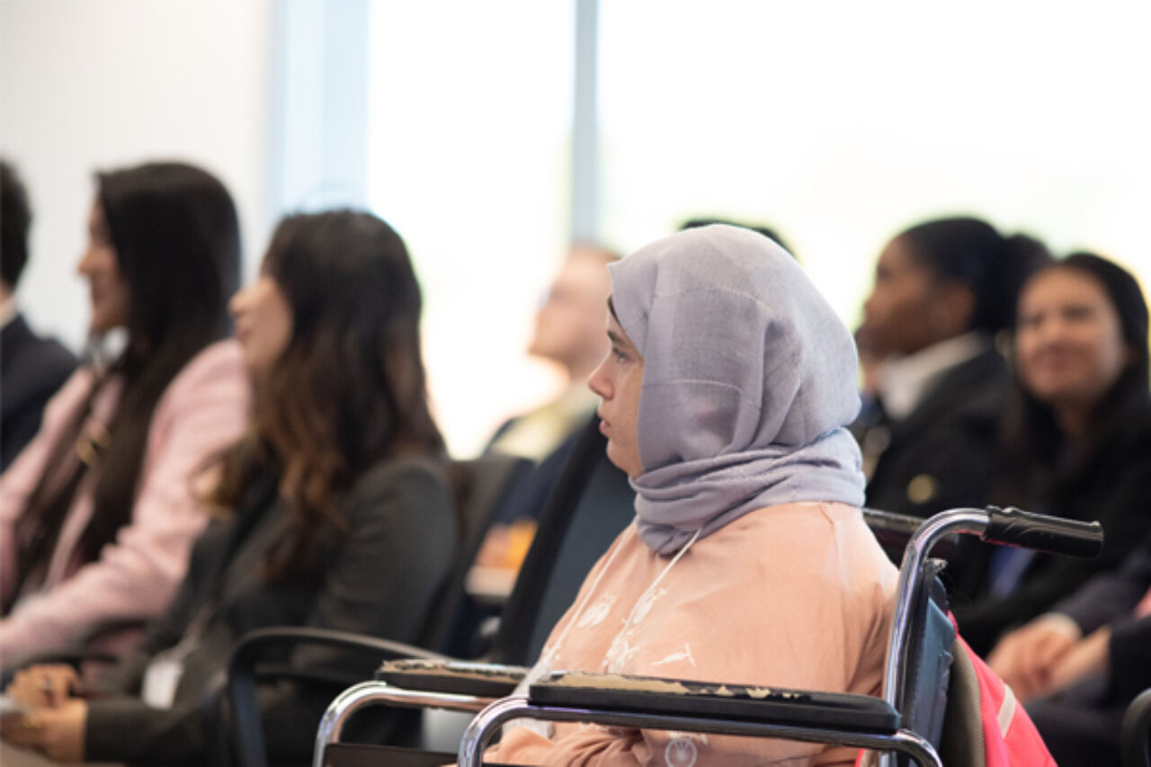 SIA student Haneen Shat watches presentation.