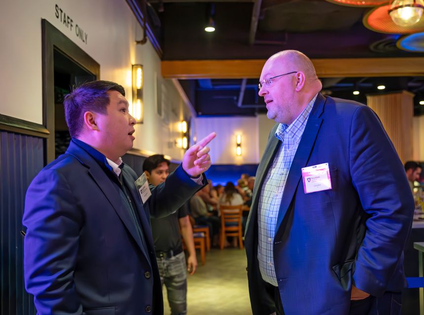 2013 alumnus Dalel Ismagulov (left) and 2011 alumnus Scott Hillkirk at the alumni reception.