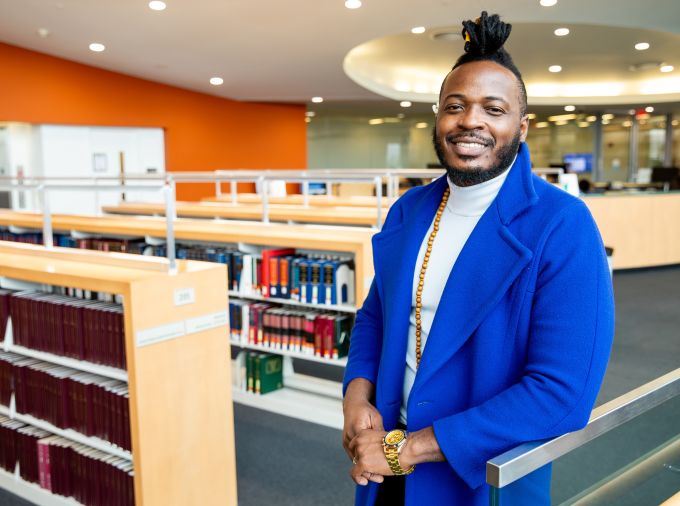 Jeferson Tenorio in the library of the Lewis Katz Building